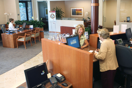 Elizabeth Juncosa, a retired accountant and longtime resident of Pacific Palisades (shown here transacting business at the teller's 